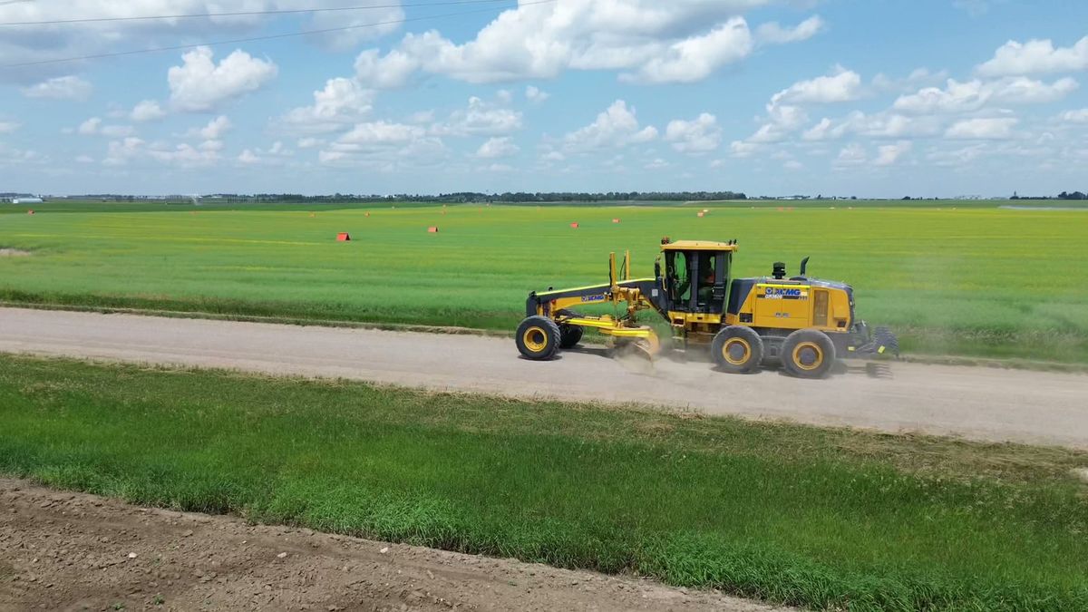 An XCMG GR2605 motor grader working a gravel road in Southern Alberta