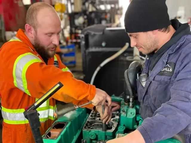 Two Foothills techs working on an engine in the Calgary shop